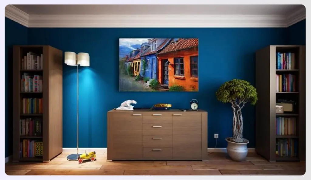 Blue living room with bookshelves and colorful art Blue living room with bookshelves and colorful art