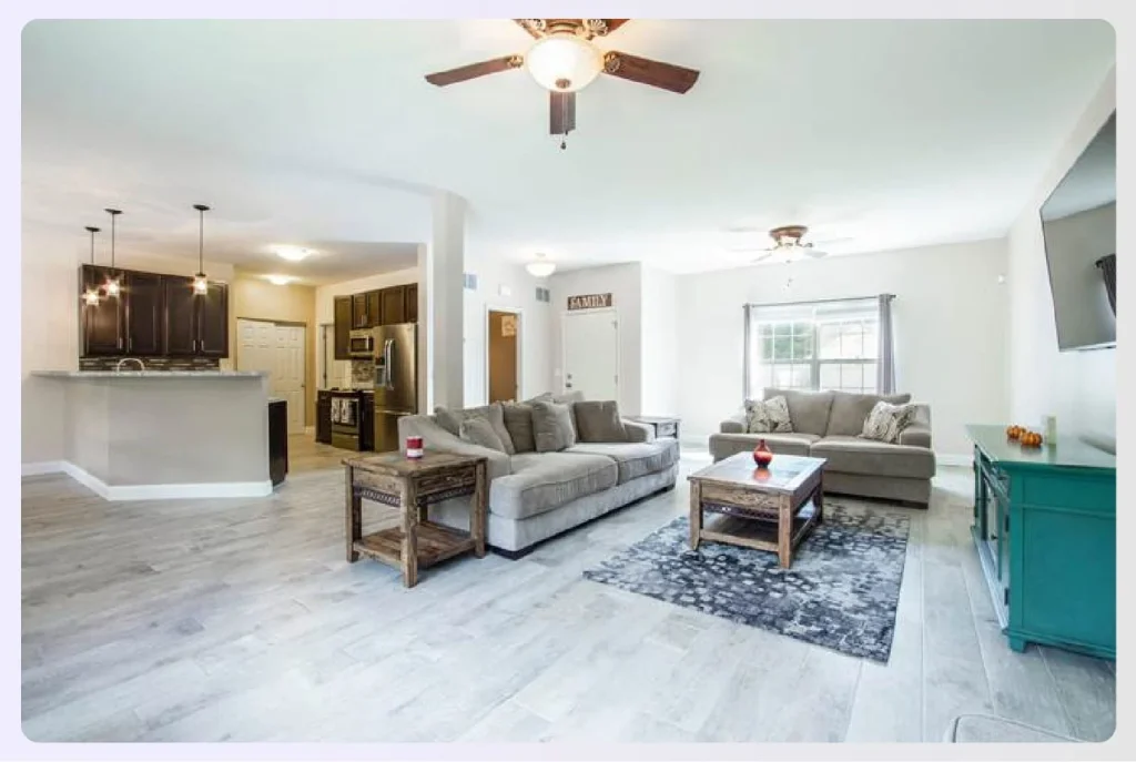 Open-plan living room and kitchen with neutral tones Open-plan living room and kitchen with neutral tones