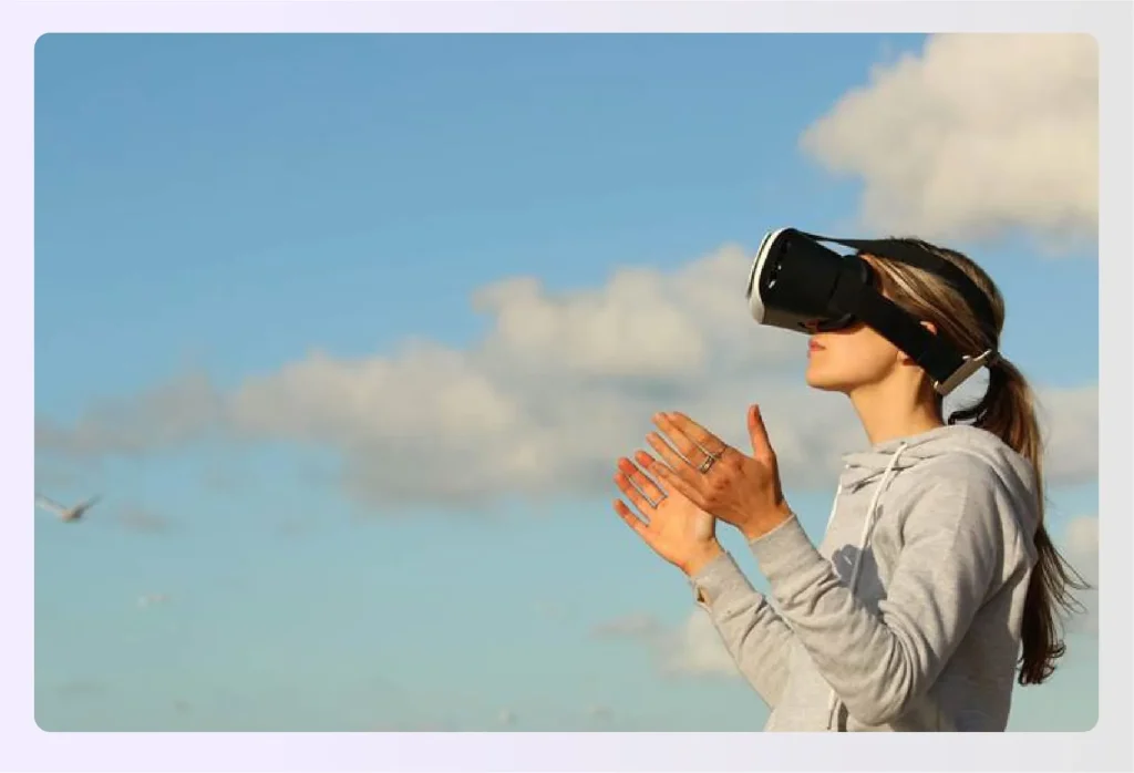 Woman using VR headset outdoors exploring virtual environmentsย Woman using VR headset outdoors exploring virtual environmentsย