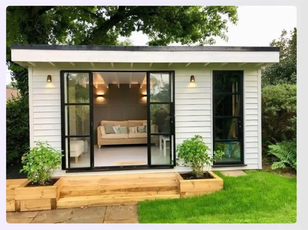 A white paneled outhouse sunroom with large windows