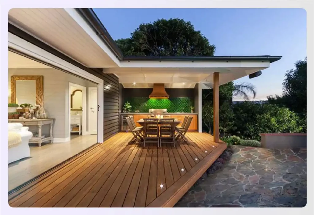 Modern home with a large wooden deck and outdoor kitchen