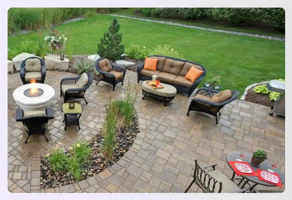 Spacious patio with stone pavers and outdoor furniture