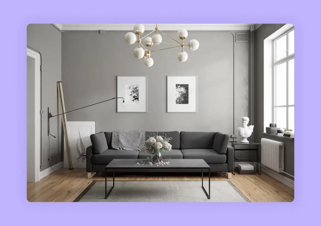 A chic living room with grey walls and a matching sofa to create a sophisticated and modern interior