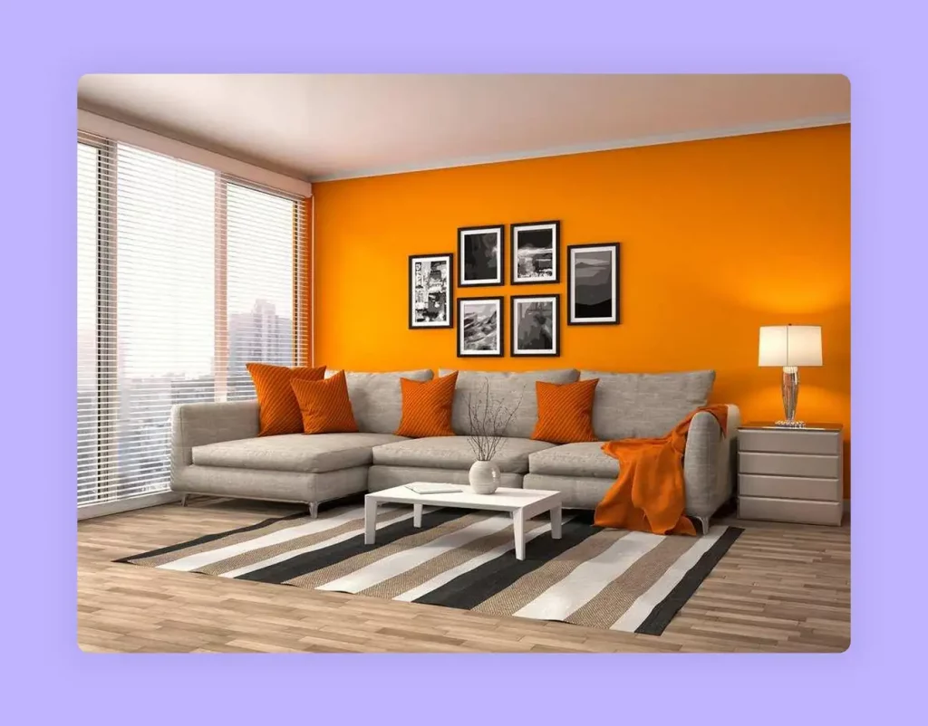 A vibrant living room with a bright orange accent wall, demonstrating how to use energetic colors