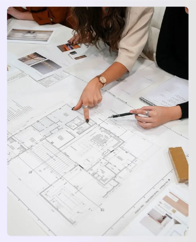 Designer and client reviewing interior design project documents