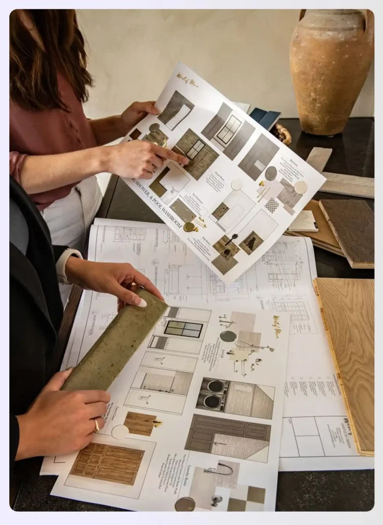 Interior designer presenting blueprints and documents to a client