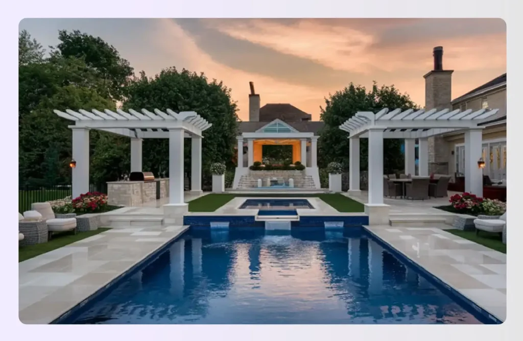 Large poolside patio with two white arbors and pavilion