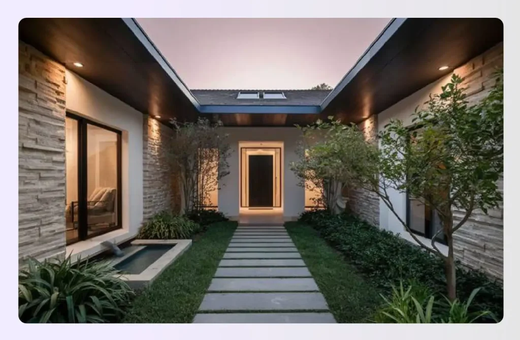 Modern courtyard entryway at dusk with stone path