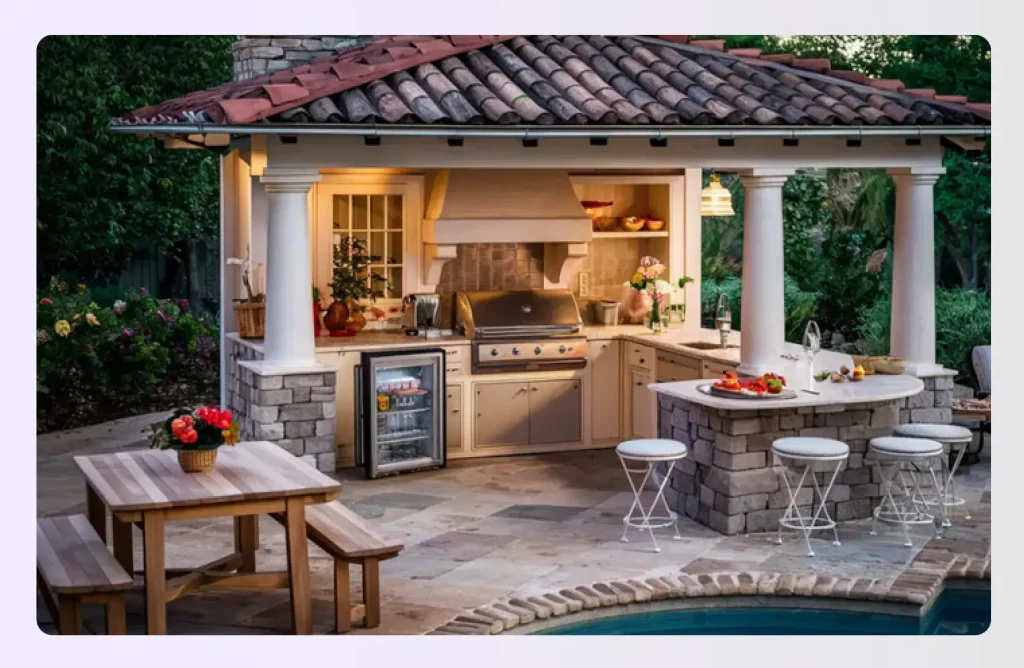 Outdoor patio kitchen with grill, bar seating, and pool