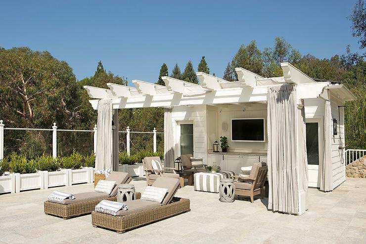 white pool house with pergola covered porch