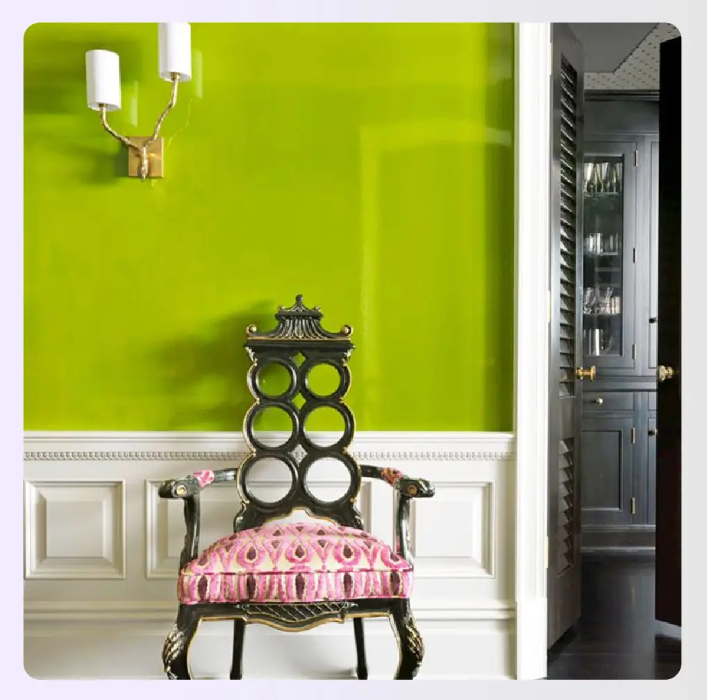 A bright lime green wall with an ornate chair