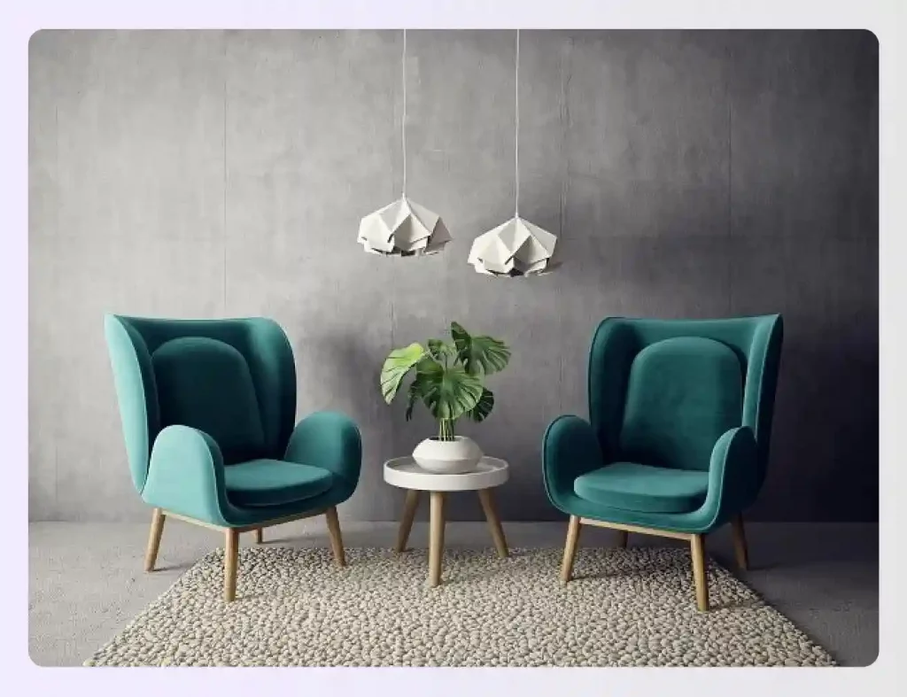 Two teal armchairs against a grey concrete wall