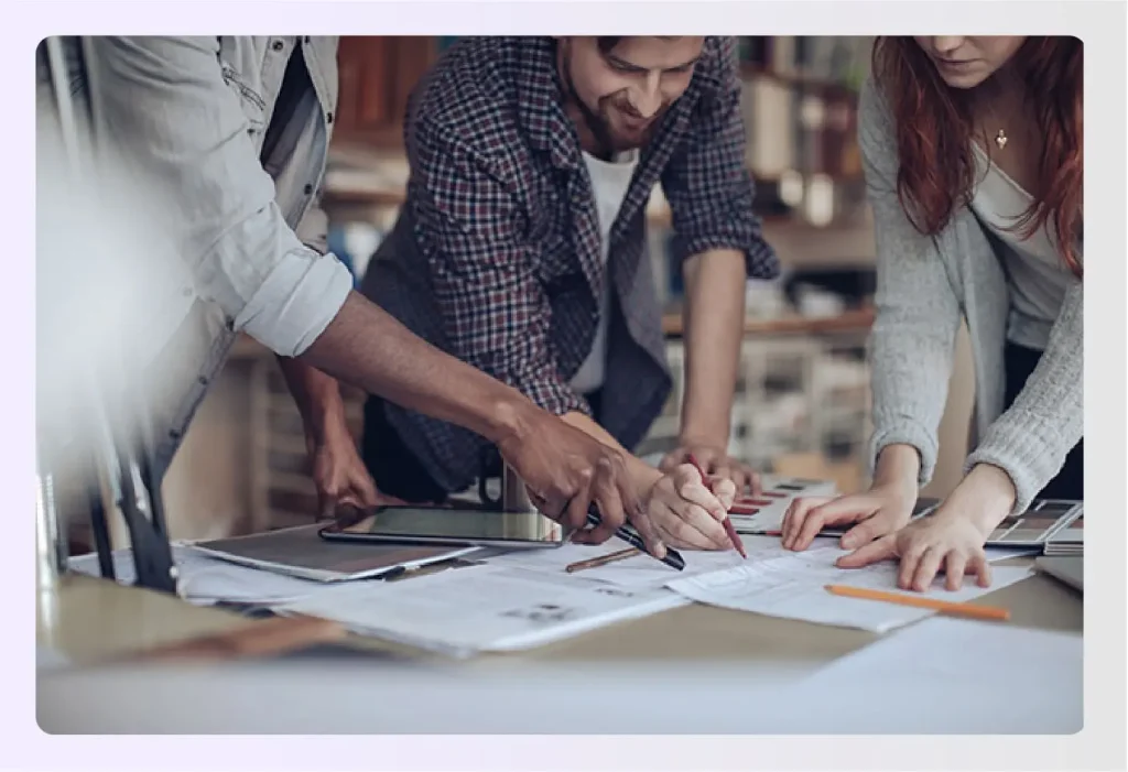 Design team collaborating over blueprints 