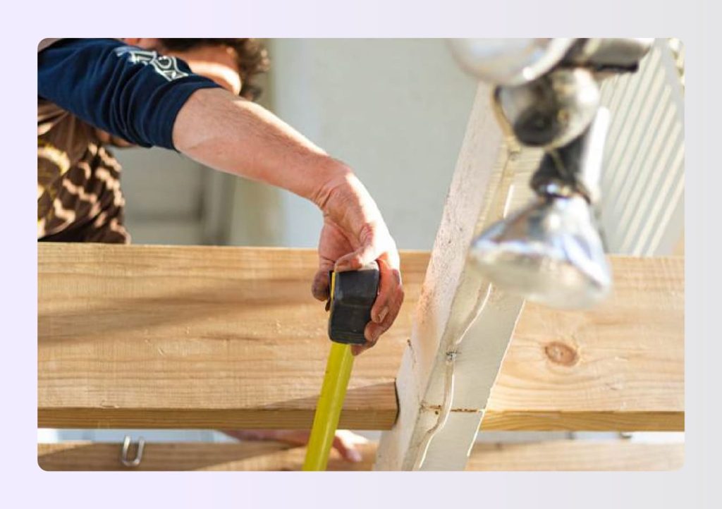 Close up of hand using yellow tape measure