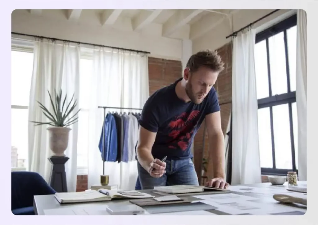 Bobby Berk working at a modern design table