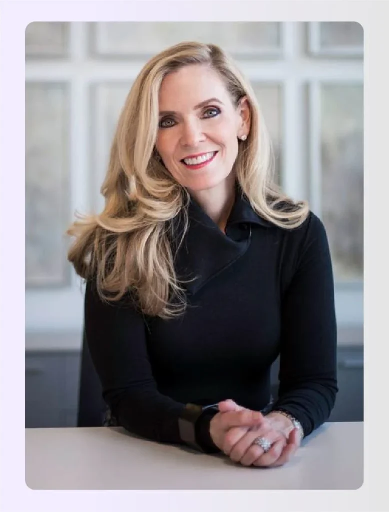 Elizabeth Lowrey smiling while sitting at a deskย Elizabeth Lowrey smiling while sitting at a deskย