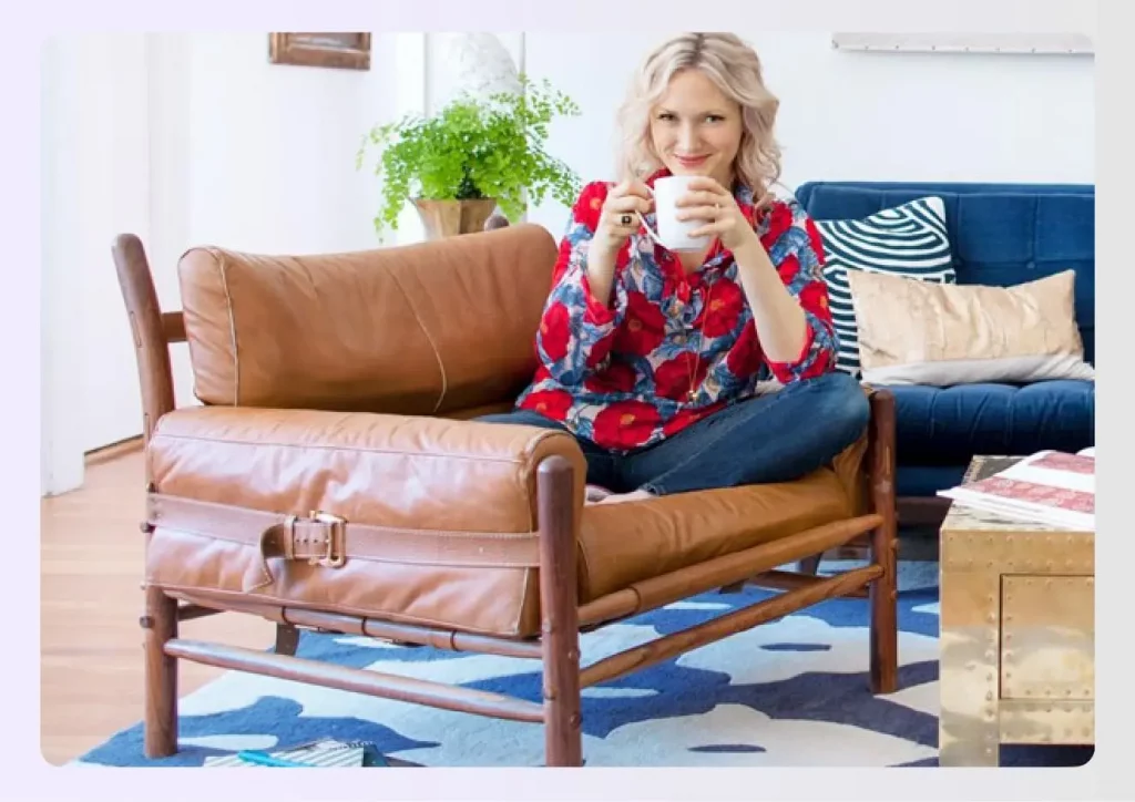 Emily Henderson sitting on a leather armchair
