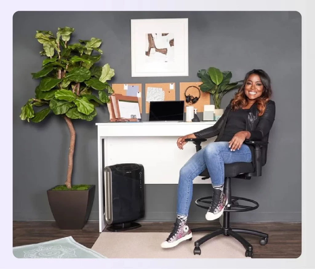 Tiffany Brooks posing at her modern desk