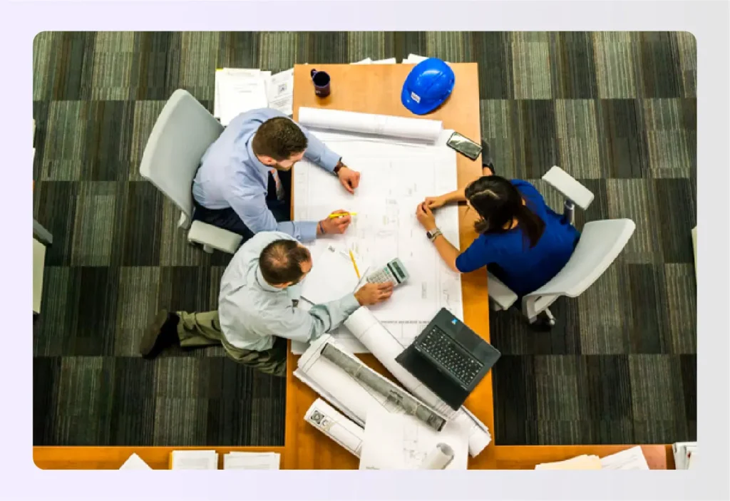 Design team collaborating on architectural plansย Design team collaborating on architectural plansย