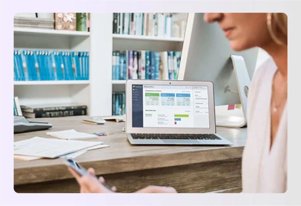 Designer checking financial dashboard on laptopย Designer checking financial dashboard on laptopย