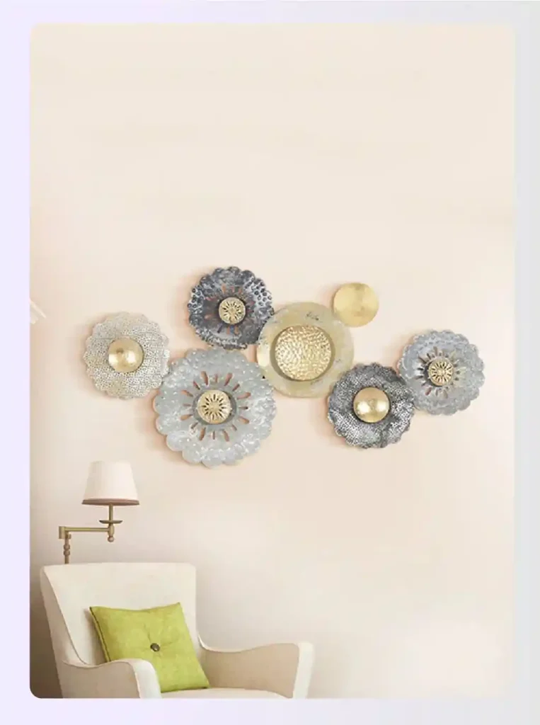 Gold and silver metal flower wall art sculpture on beige wall Gold and silver metal flower wall art sculpture on beige wall