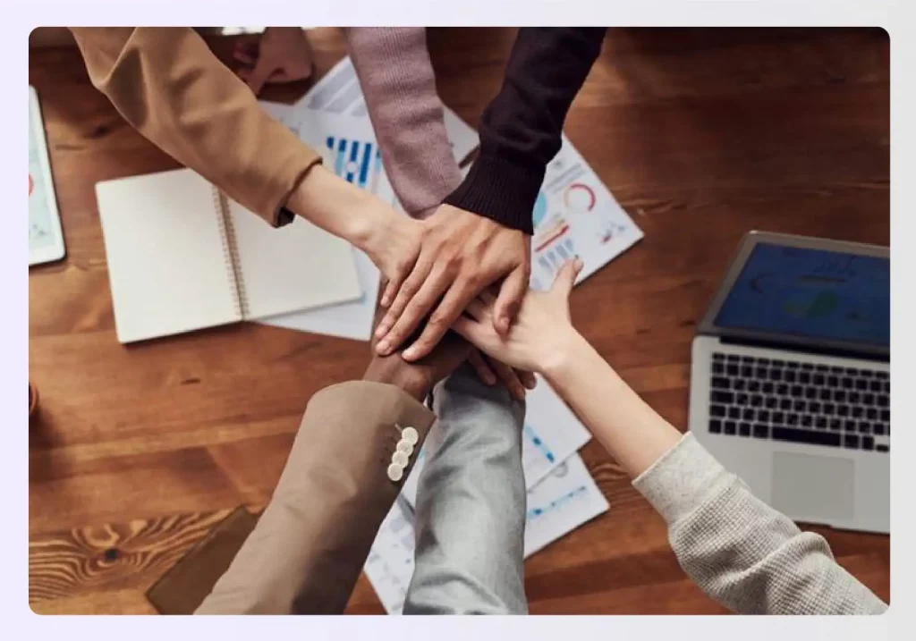 A design team putting their hands together in collaboration