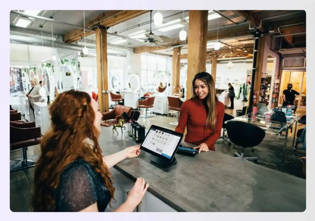 An interior designer interacting with a client at a desk