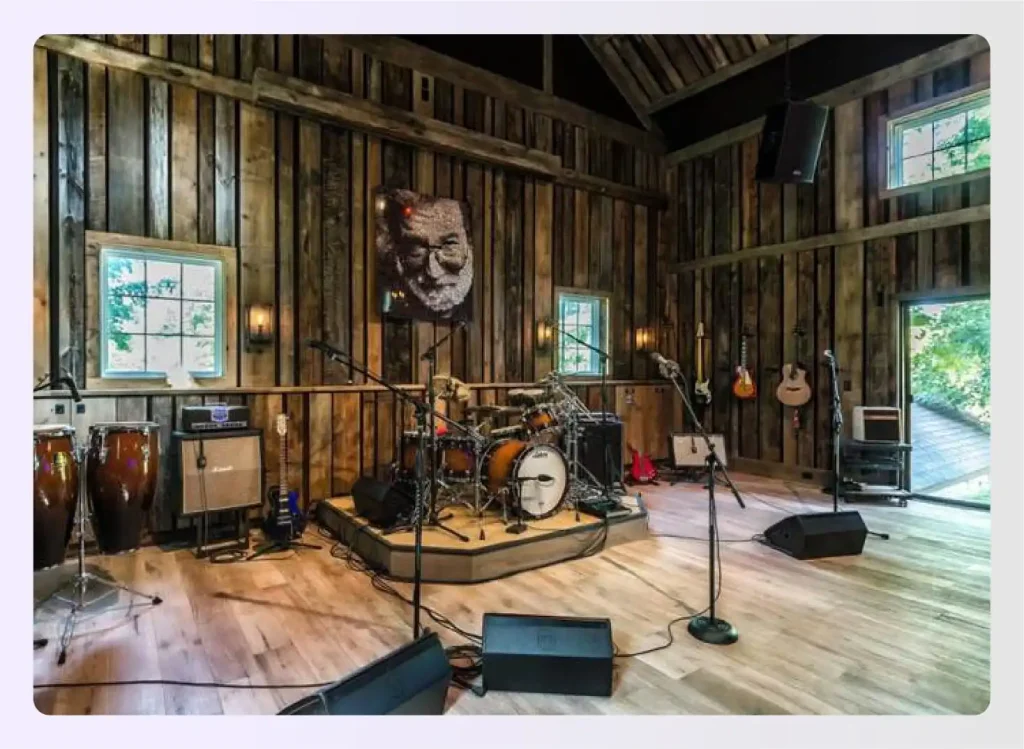 Rustic barn-wood music room with a performance stage