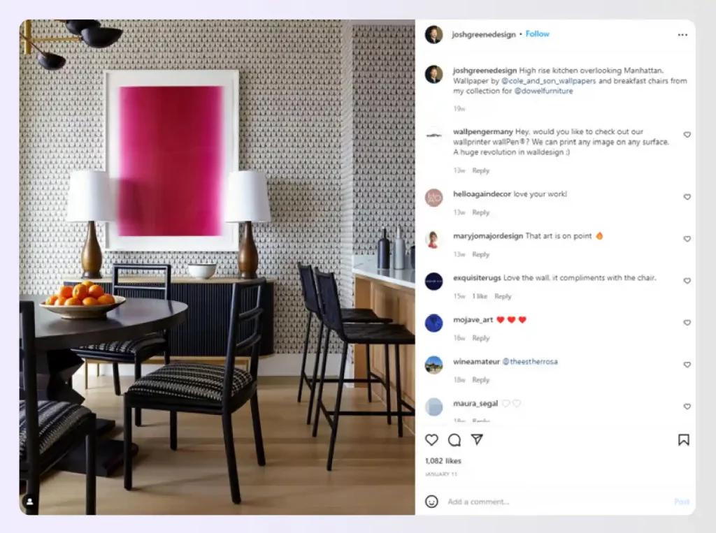 A dining area with geometric wallpaper and bold art