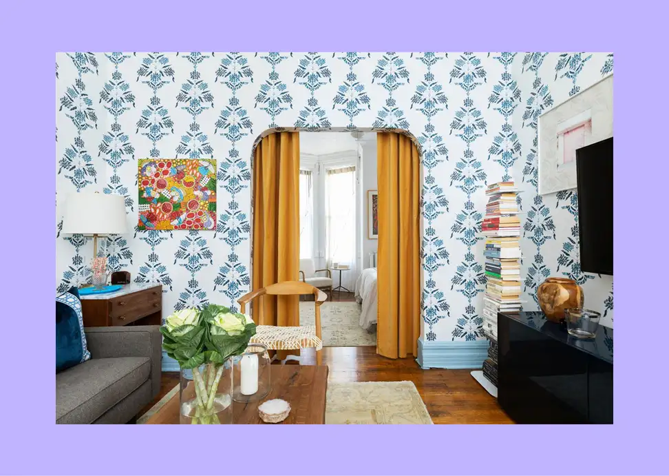 An open-plan room cleverly divided into zones using furniture and rugs.