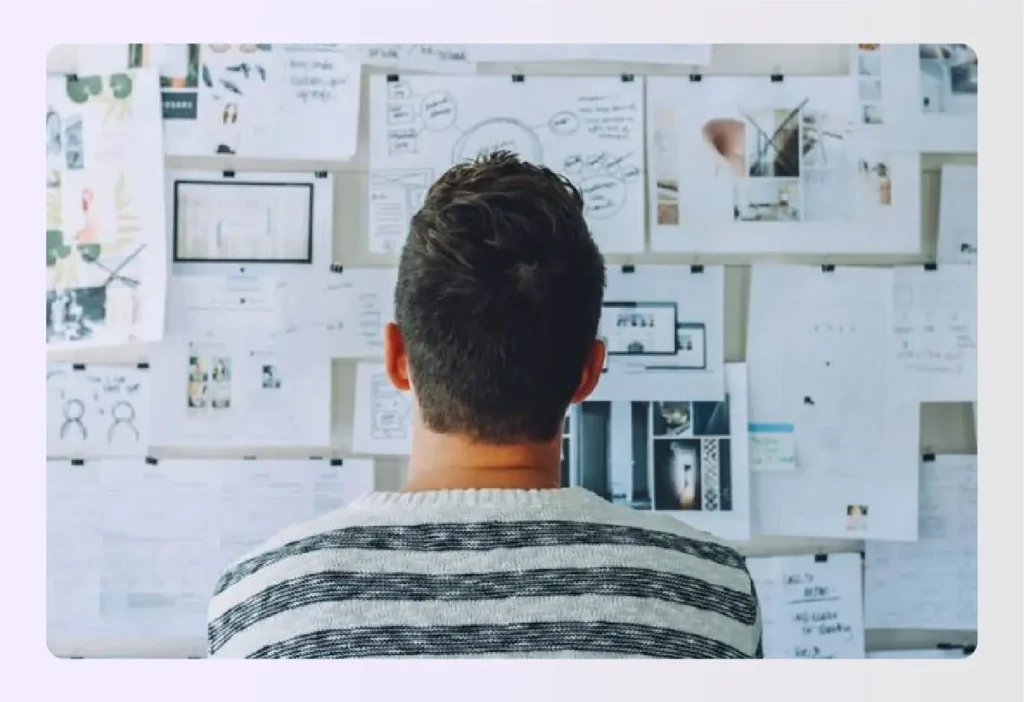 Designer reviewing wall of interior design project plans