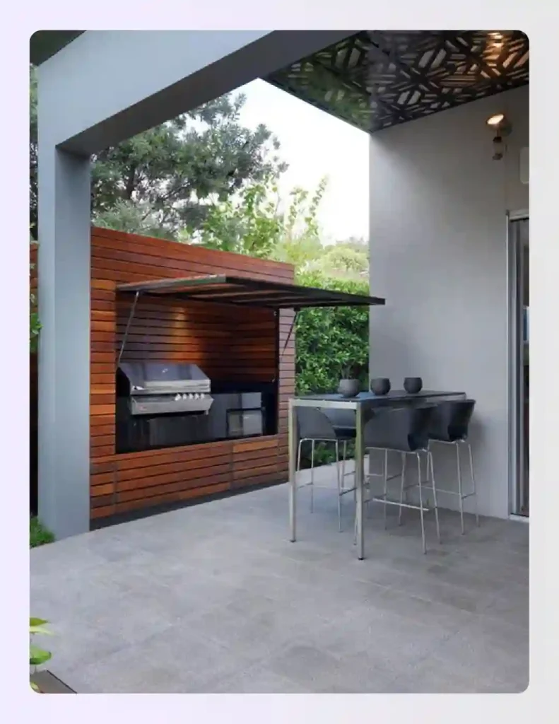 Modern outdoor kitchen hidden behind a folding wooden door Modern outdoor kitchen hidden behind a folding wooden door