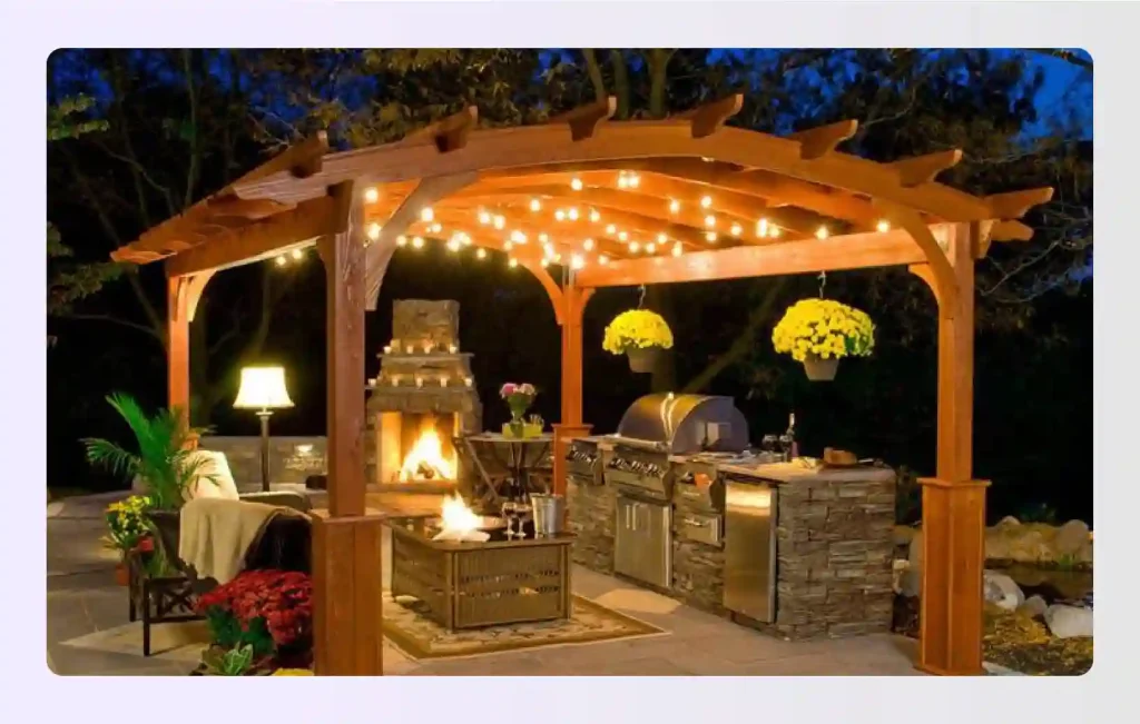 Pergola with string lights over an outdoor kitchen and living area Pergola with string lights over an outdoor kitchen and living area
