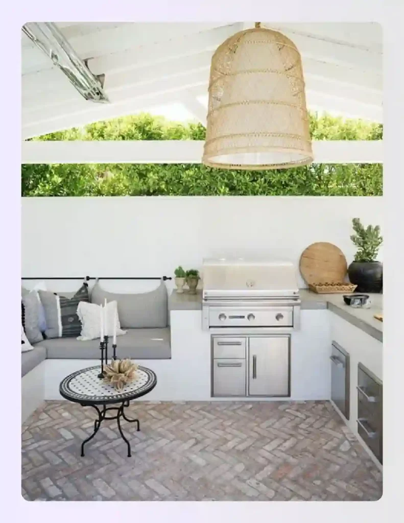 White stucco outdoor kitchen with herringbone brick floor and hanging lights White stucco outdoor kitchen with herringbone brick floor and hanging lights