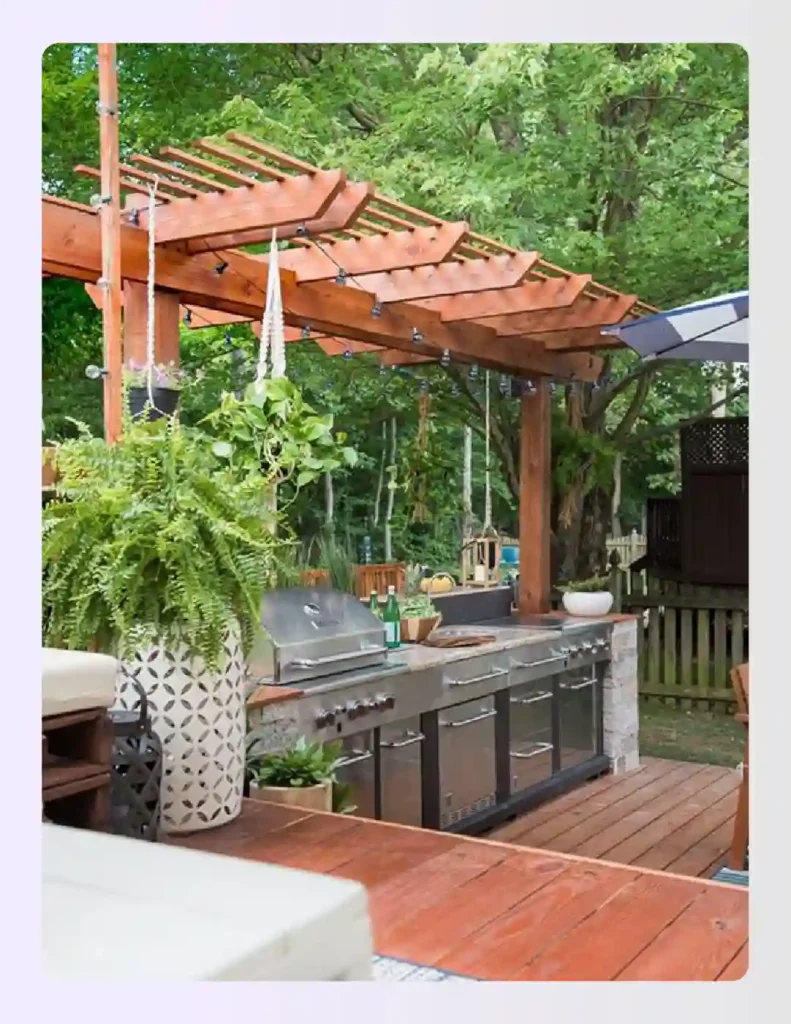 Wooden pergola covering a stone outdoor kitchen with hanging plants Wooden pergola covering a stone outdoor kitchen with hanging plants