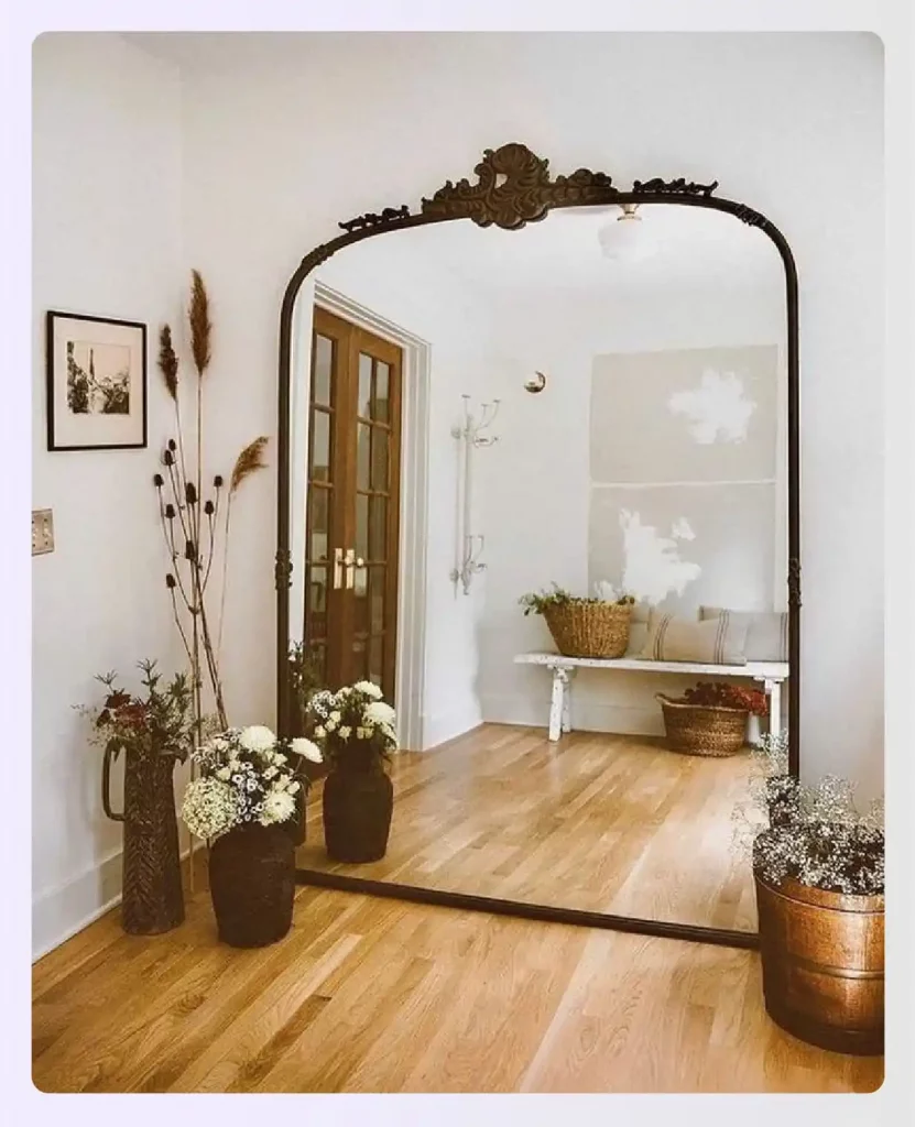 Large ornate mirror leaning against a wall