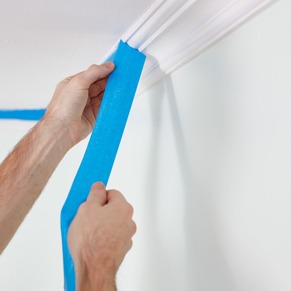 how to paint a room - stick tape with a putty knife
