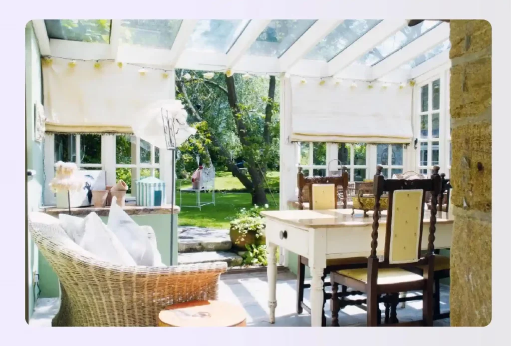 Cozy and sun-filled conservatory with rustic dining furniture
