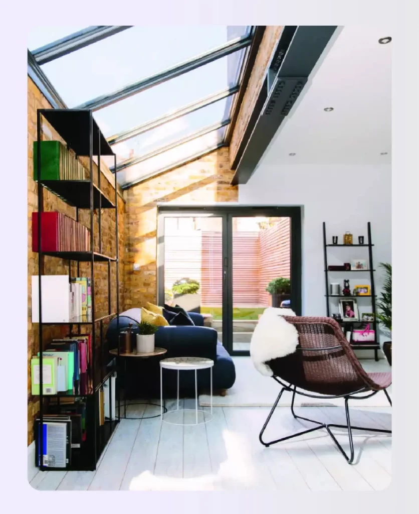 Sunlit living room featuring a sloped glass roof extension