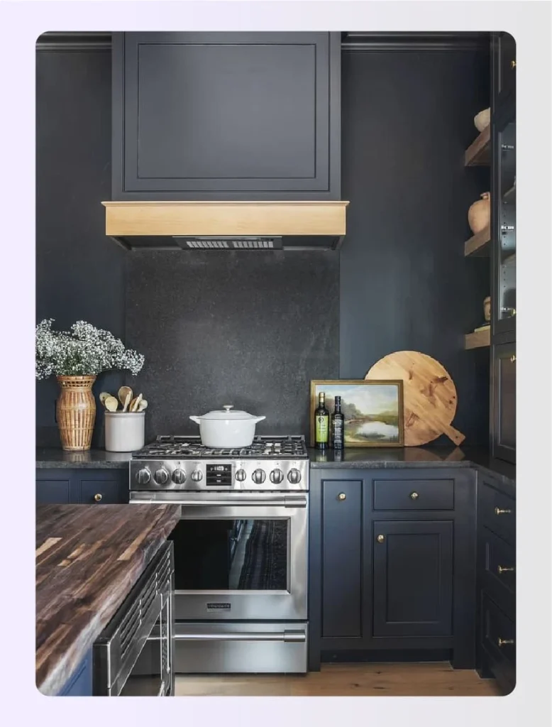 Black kitchen joinery with pink dining chairs 