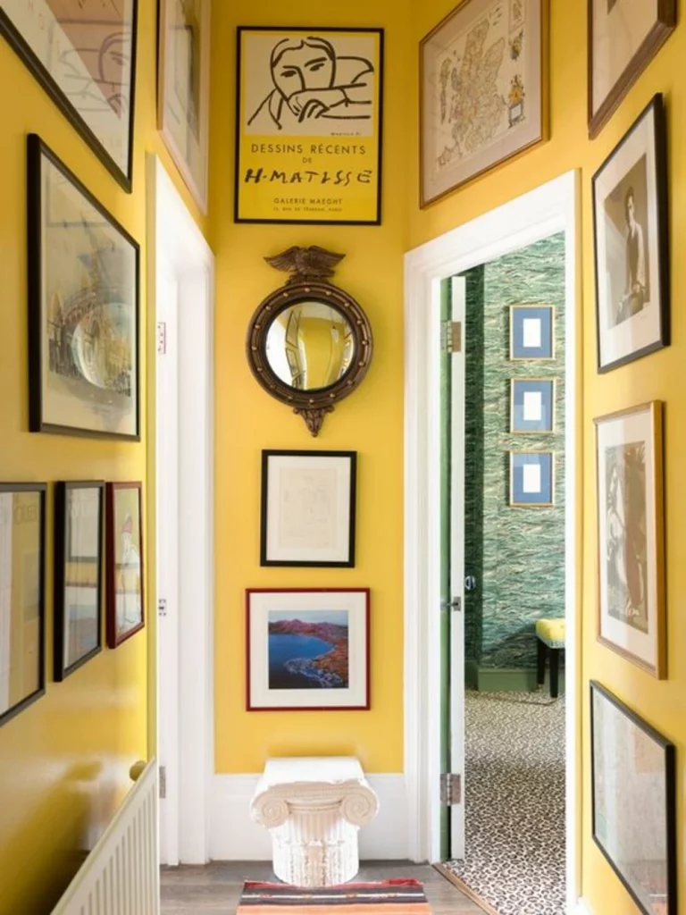 hallway color schemes - pastel yellow with multi-color frames