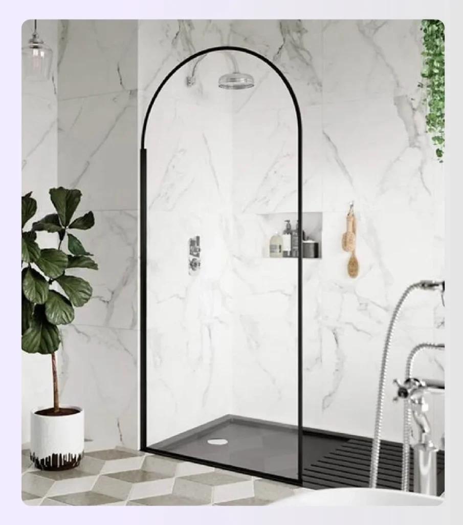 Black framed arched glass shower screen in marble bathroom Black framed arched glass shower screen in marble bathroom