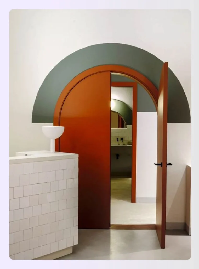 Modern arched doorway with green and terracotta accents Modern arched doorway with green and terracotta accents