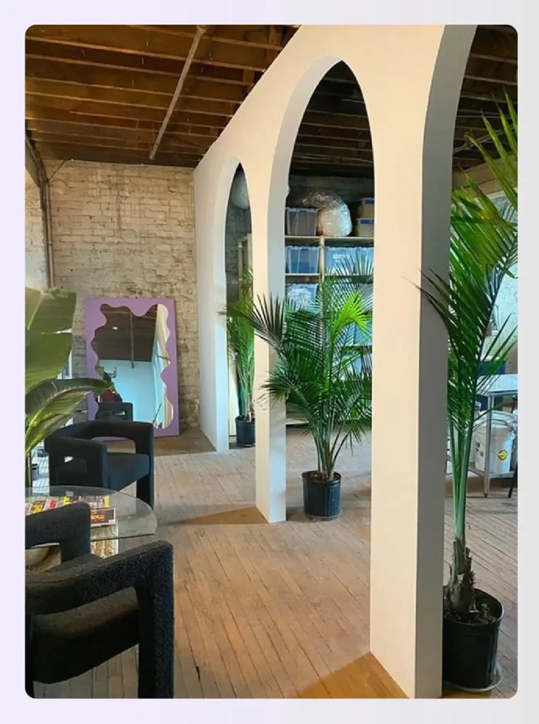 White arched room dividers separating living and storage areas White arched room dividers separating living and storage areas