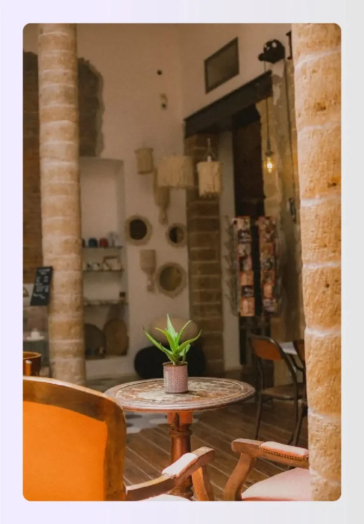Small cafe table featuring a bright potted plant Small cafe table featuring a bright potted plant