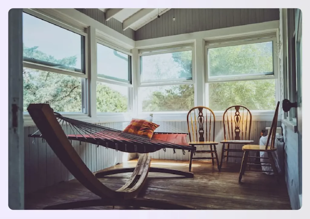 An enclosed back patio with a hammock