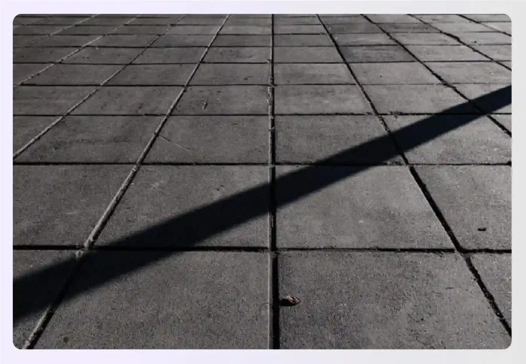 Dark square concrete paver flooring on a patio