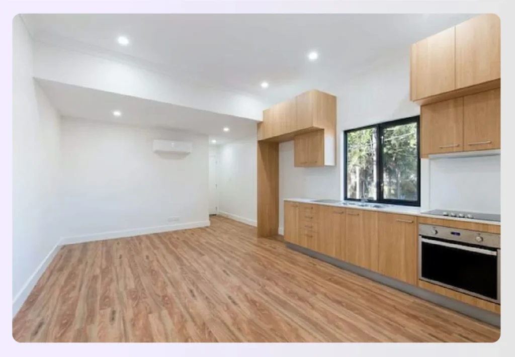 Modern kitchen area with light hardwood floors