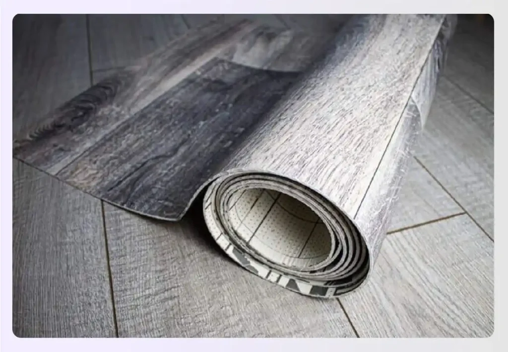 Roll of grey wood-grain linoleum flooring sheet