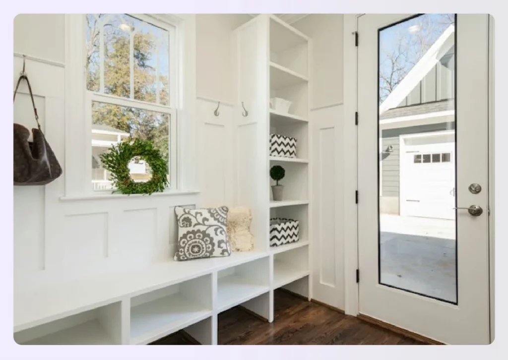 White mudroom with built-in storage and hooks